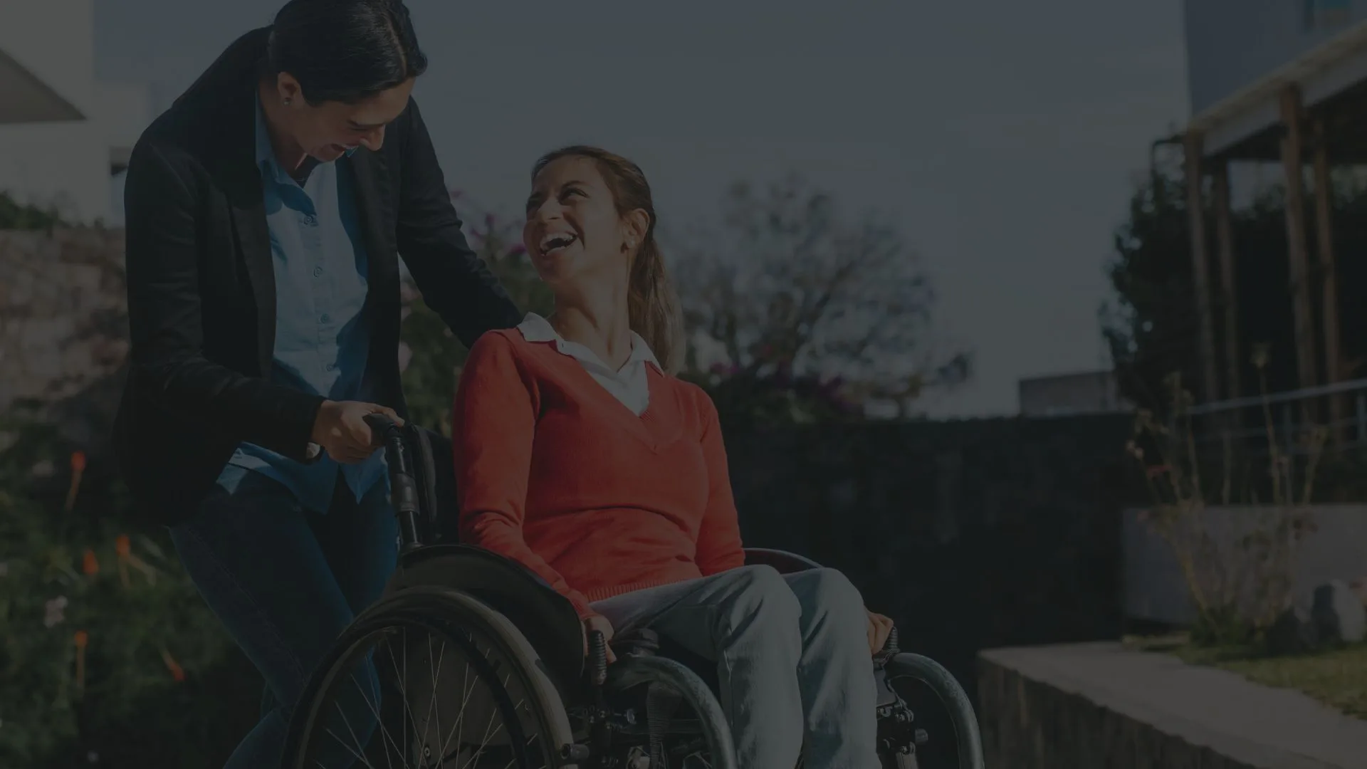 Happy passenger receiving wheelchair assistance from Duke Family Transportation driver